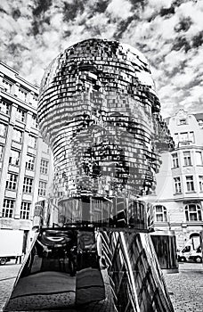 Moving statue of Franz Kafka in Prague, colorless